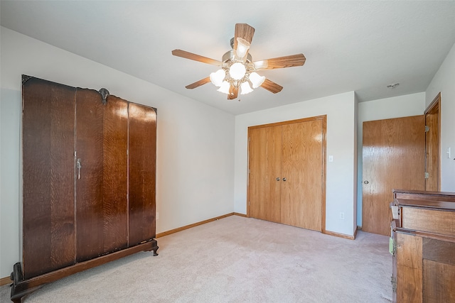 unfurnished bedroom with light colored carpet and ceiling fan