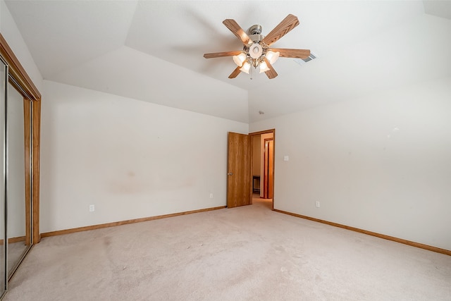 unfurnished bedroom with lofted ceiling, light colored carpet, a closet, and ceiling fan