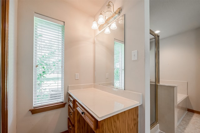 bathroom featuring vanity, tile patterned floors, independent shower and bath, and plenty of natural light