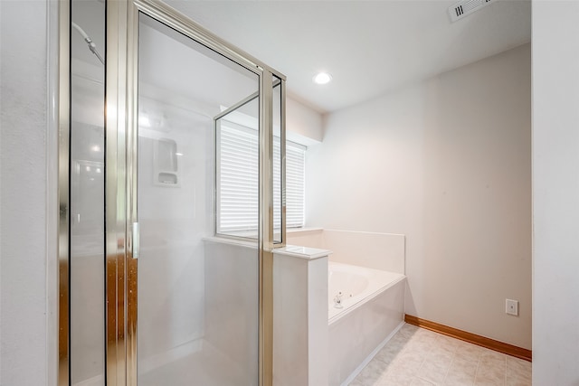 bathroom featuring tile patterned floors and shower with separate bathtub