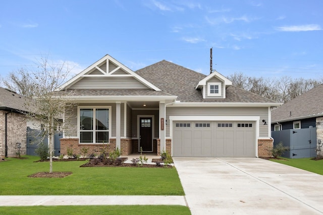 craftsman-style home featuring a front yard and a garage