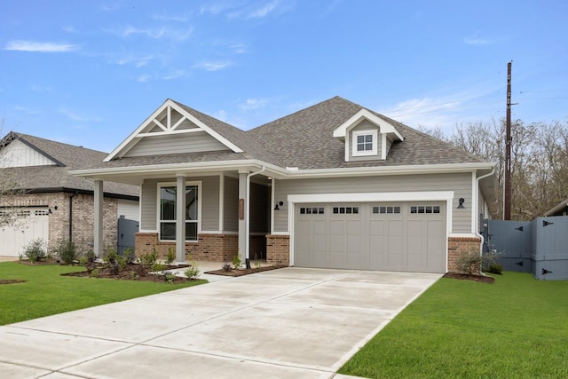 craftsman-style home featuring a front lawn and a garage