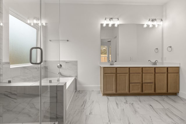 bathroom with vanity and shower with separate bathtub