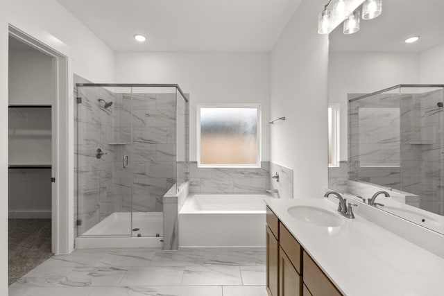 bathroom featuring vanity and independent shower and bath