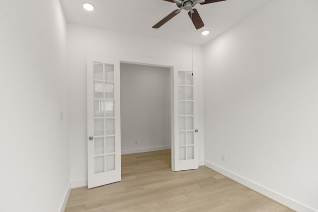 unfurnished room with french doors, light hardwood / wood-style flooring, and ceiling fan