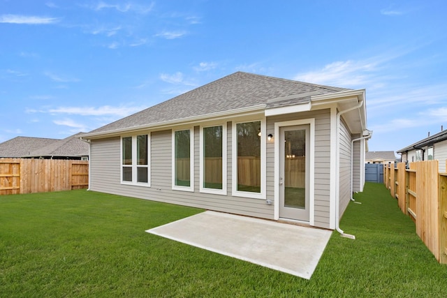 back of property featuring a lawn and a patio area