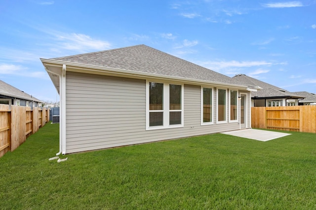 back of property featuring a yard and a patio