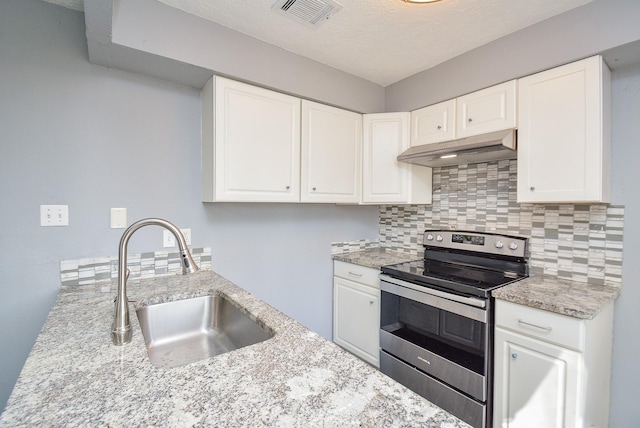 kitchen featuring white cabinets and electric range