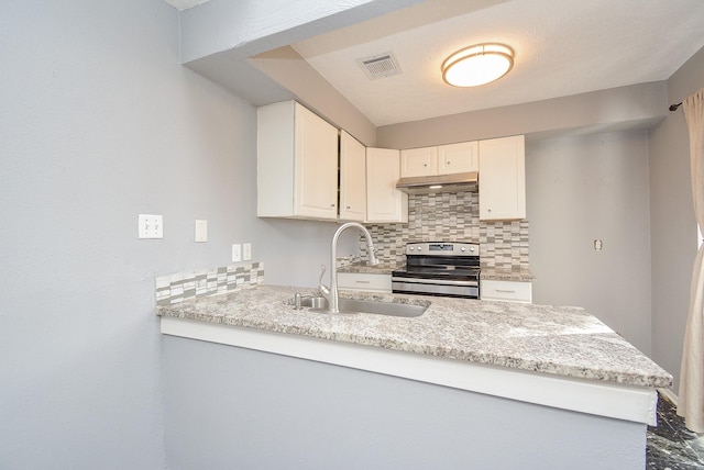 kitchen with backsplash, white cabinetry, stainless steel electric range oven, and sink