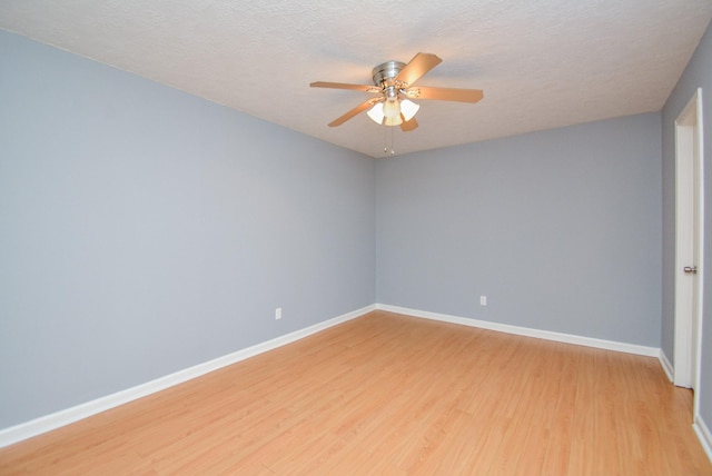 empty room featuring ceiling fan, light hardwood / wood-style floors, and a textured ceiling