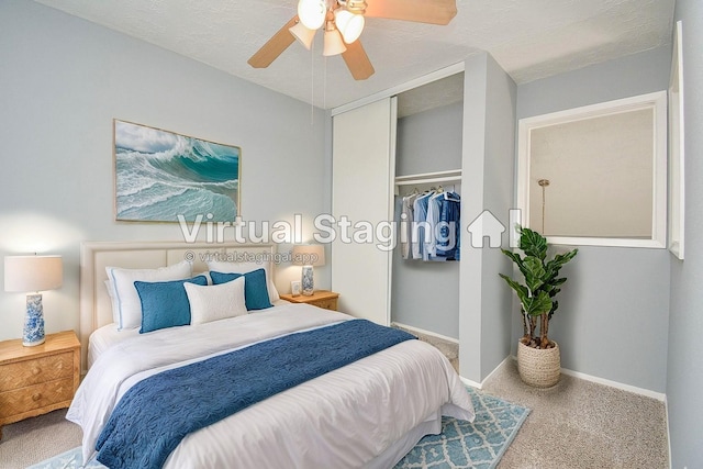 carpeted bedroom featuring ceiling fan, a textured ceiling, and a closet