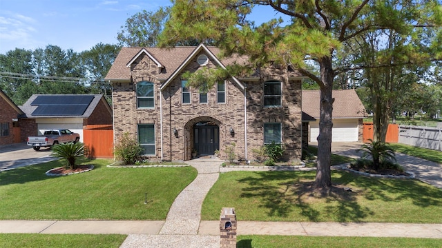 view of front of house featuring a garage and a front lawn