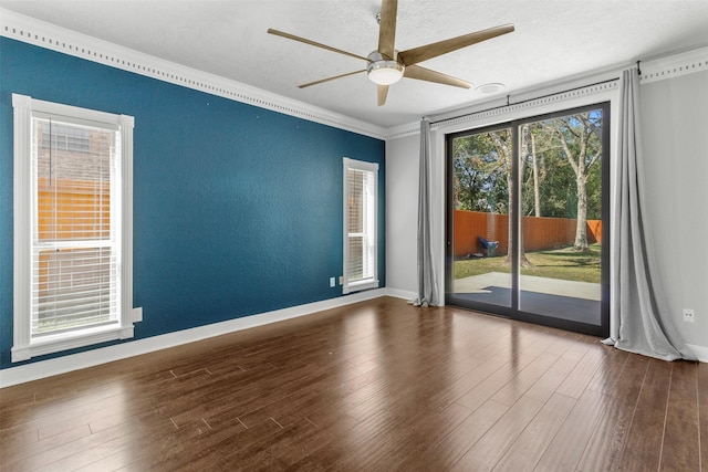 empty room with hardwood / wood-style floors, ceiling fan, ornamental molding, and a textured ceiling