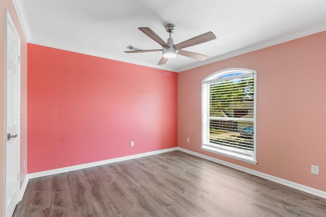 spare room featuring hardwood / wood-style floors, ceiling fan, and ornamental molding