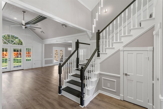 staircase with ceiling fan, french doors, hardwood / wood-style floors, and ornamental molding