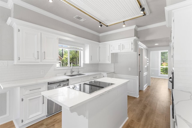 kitchen featuring white cabinets, sink, dishwasher, a center island, and light hardwood / wood-style floors