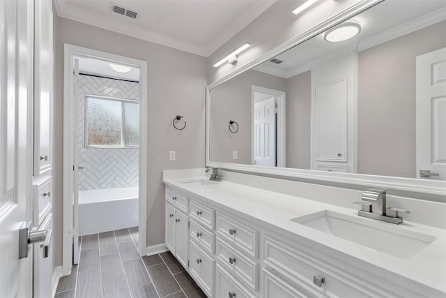 bathroom featuring crown molding, vanity, and tiled shower / bath