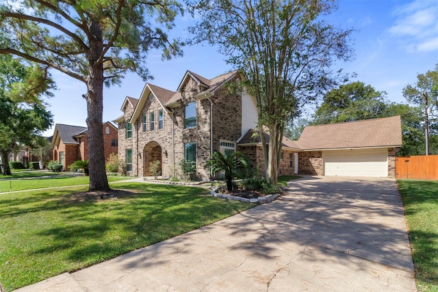 view of front of house with a front yard and a garage