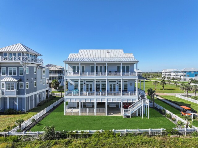 11707 Beachside, Galveston, TX 77554 - back of house featuring a balcony, a patio area, metal roof, and french doors