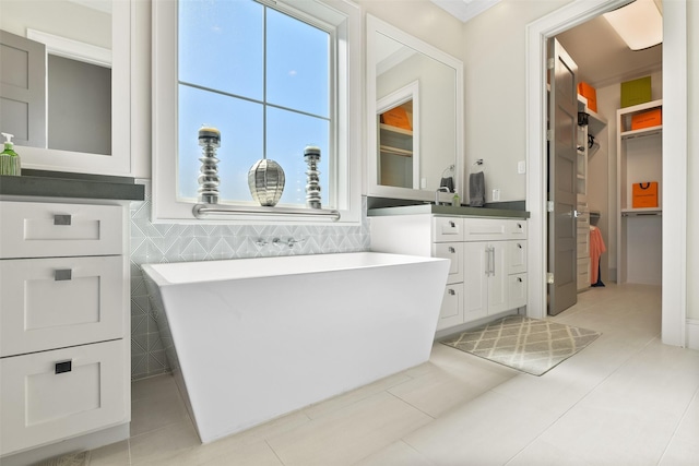 11707 Beachside, Galveston, TX 77554 - full bath featuring vanity, a soaking tub, a walk in closet, and tile patterned floors