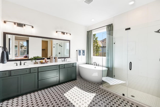 bathroom with vanity and independent shower and bath