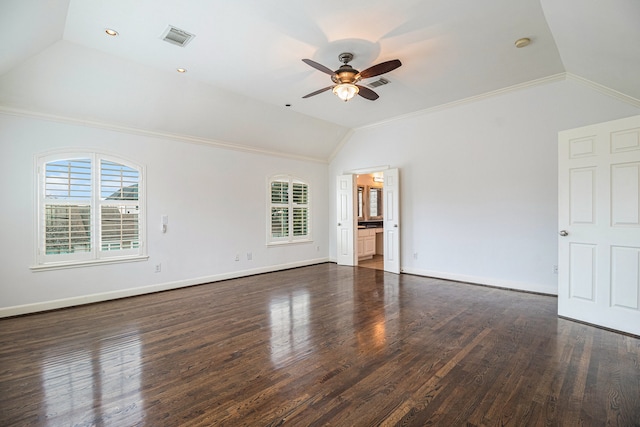 empty room featuring dark wood-type flooring, lofted ceiling, ceiling fan, and crown molding