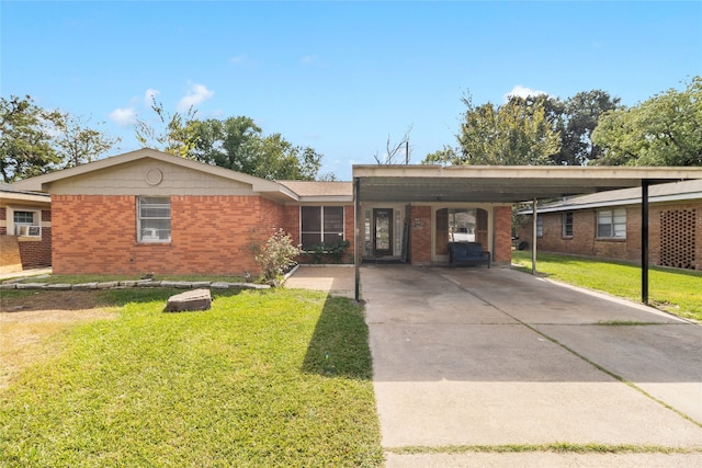 ranch-style home featuring a front lawn and a carport