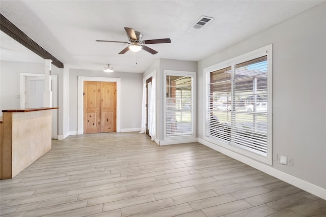 unfurnished living room with ceiling fan and light hardwood / wood-style flooring