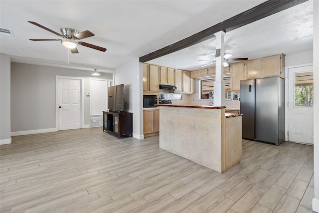 kitchen featuring light brown cabinetry, a center island, light hardwood / wood-style floors, and stainless steel refrigerator