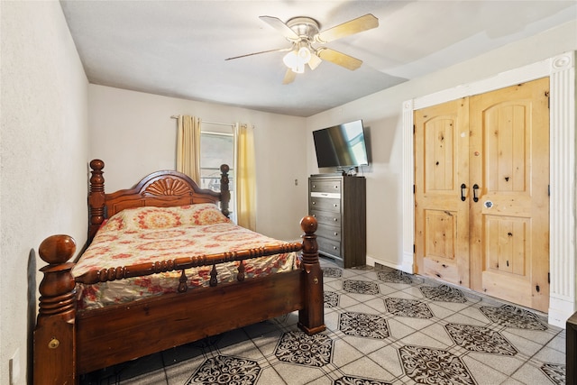 tiled bedroom featuring ceiling fan