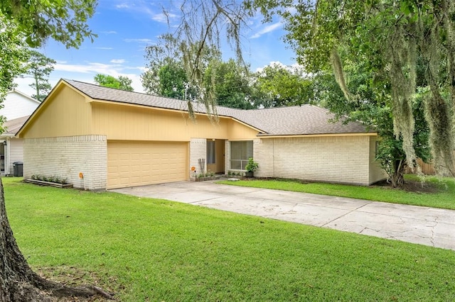 single story home featuring a front lawn and a garage