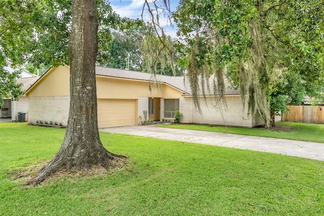 ranch-style house featuring a front lawn and a garage