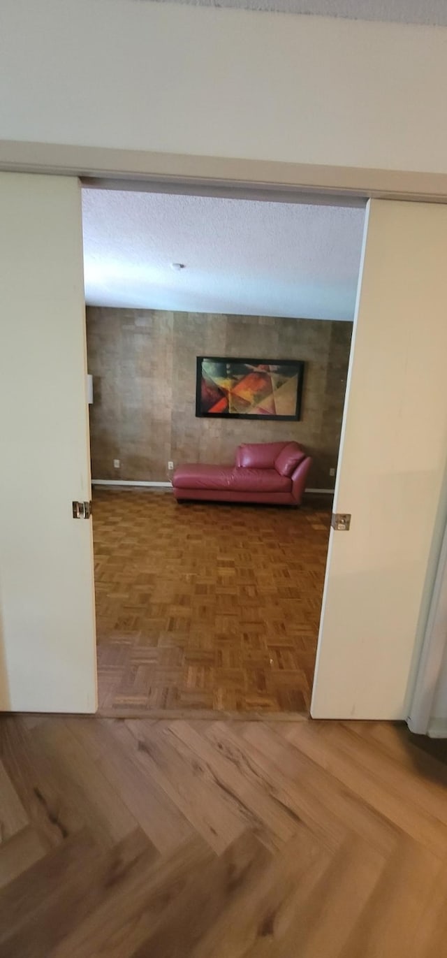 hallway featuring parquet flooring