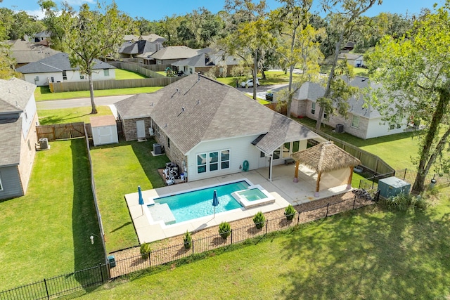 view of swimming pool with a patio, a gazebo, a lawn, and central AC unit