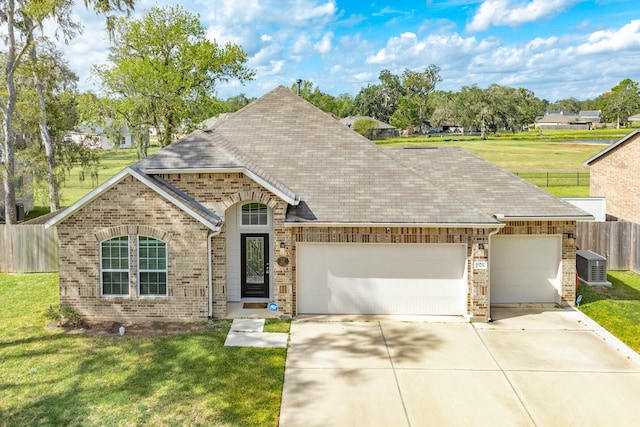 view of front of house featuring a front yard and a garage