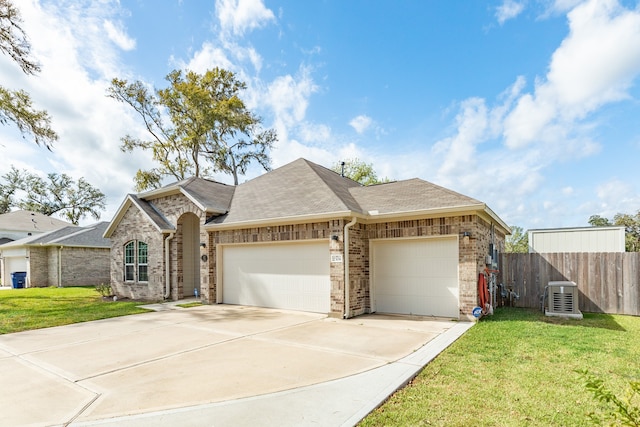 ranch-style home with a front yard, central AC, and a garage