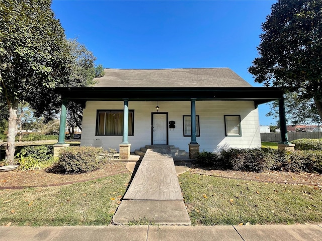 bungalow-style home with fence and covered porch
