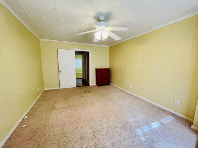 unfurnished bedroom with ornamental molding, carpet flooring, and ceiling fan