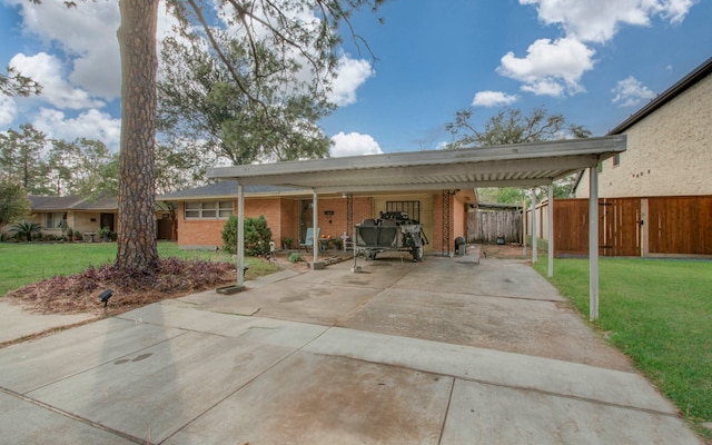 view of car parking with a yard and a carport