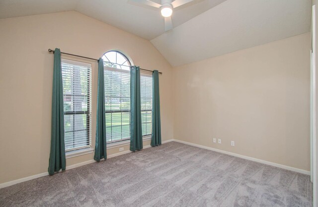 carpeted empty room with ceiling fan and vaulted ceiling