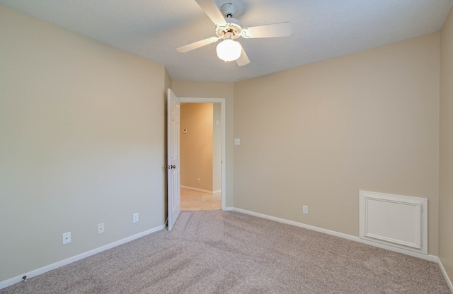 unfurnished room with light colored carpet and ceiling fan