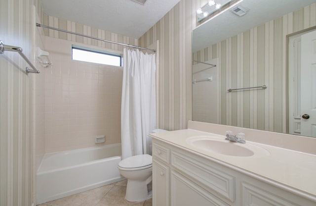 full bathroom with a textured ceiling, toilet, shower / bath combo with shower curtain, vanity, and tile patterned floors