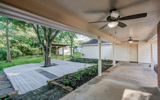 view of patio / terrace with a wooden deck and a ceiling fan