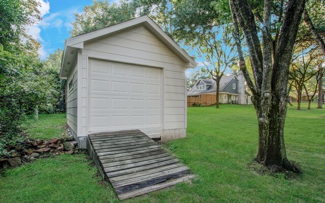 garage with wooden walls and a lawn