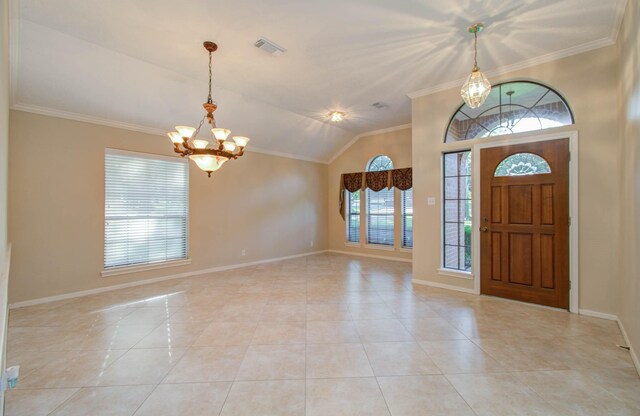 entrance foyer with crown molding, a healthy amount of sunlight, light tile patterned floors, and a chandelier