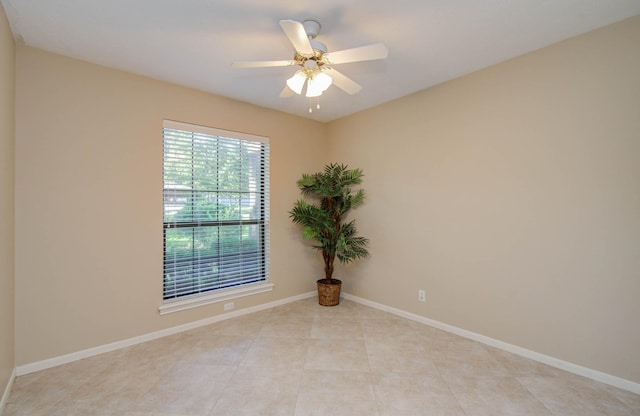 unfurnished room featuring light tile patterned floors, baseboards, and a ceiling fan