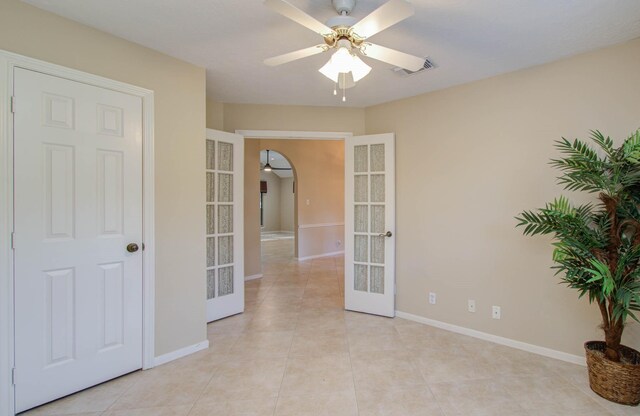 unfurnished room with french doors, ceiling fan, and light tile patterned flooring