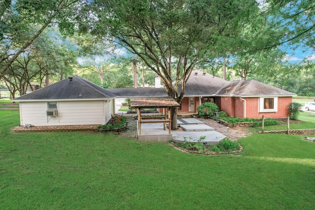 back of house featuring cooling unit, brick siding, a yard, and a wooden deck