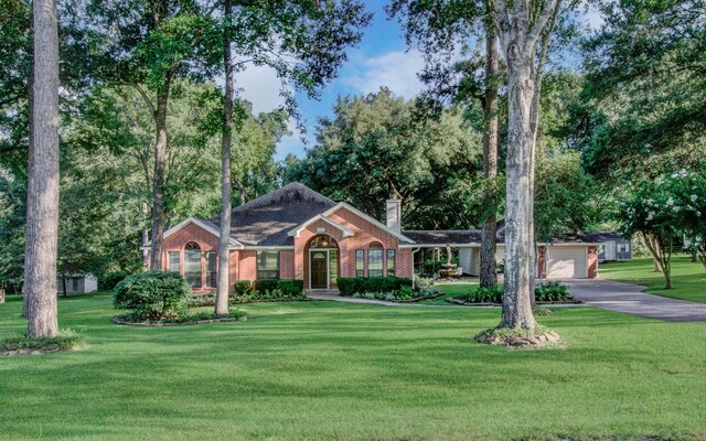 ranch-style home with a front yard and a garage