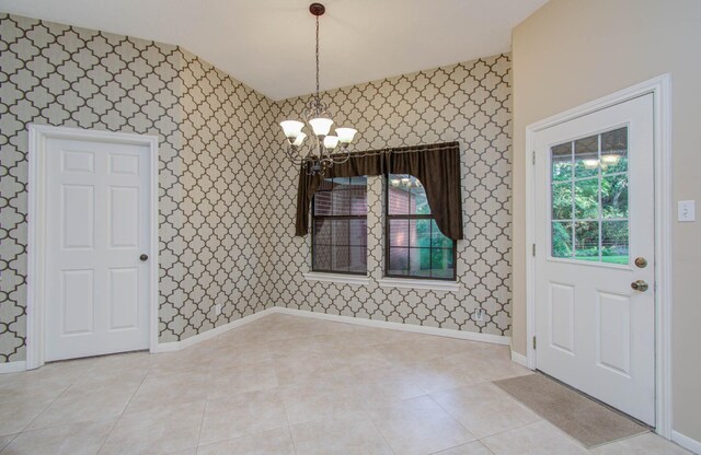 interior space with light tile patterned flooring, baseboards, an inviting chandelier, and wallpapered walls